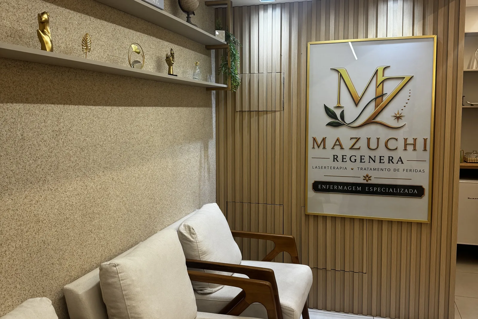 Parede da recepção com a placa da Mazuchi Regenera e as poltronas de espera